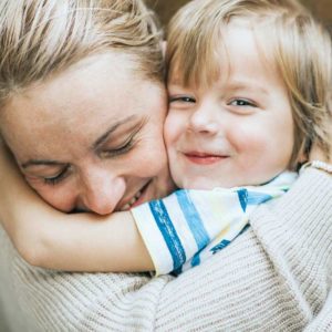 Hugging woman and little boy